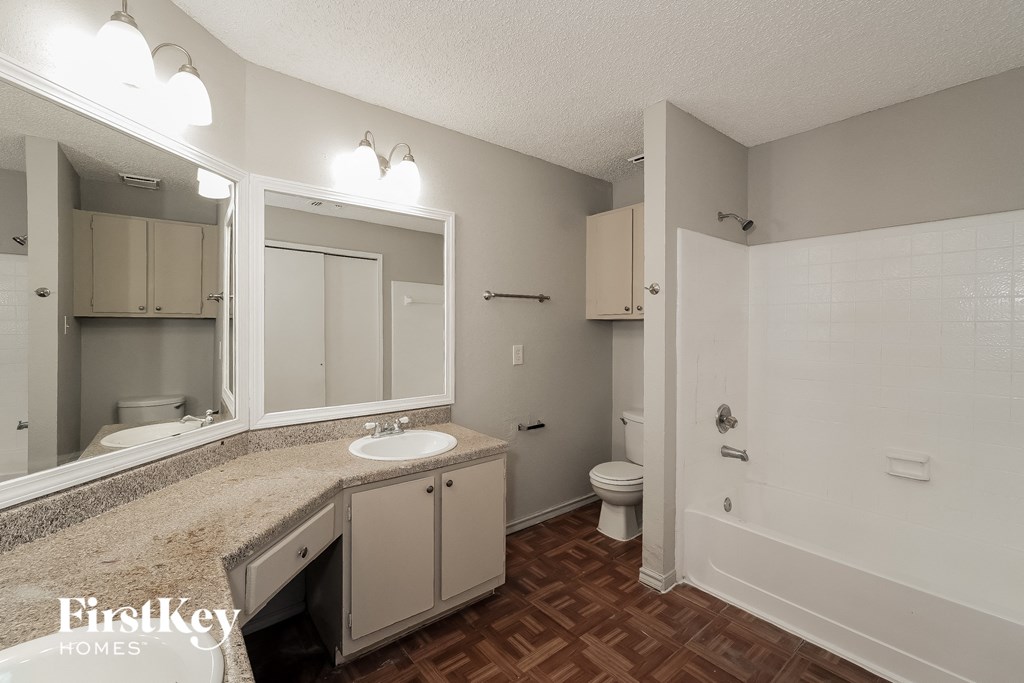 a bathroom with a sink and a mirror and a toilet