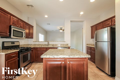 a kitchen with granite countertops and stainless steel appliances