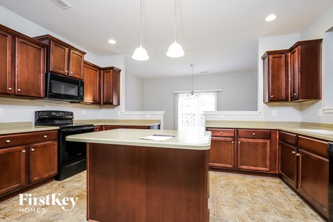 a kitchen with wooden cabinets and a white counter top