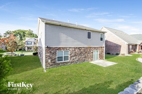 a view of the backyard of a house with a yard and grass