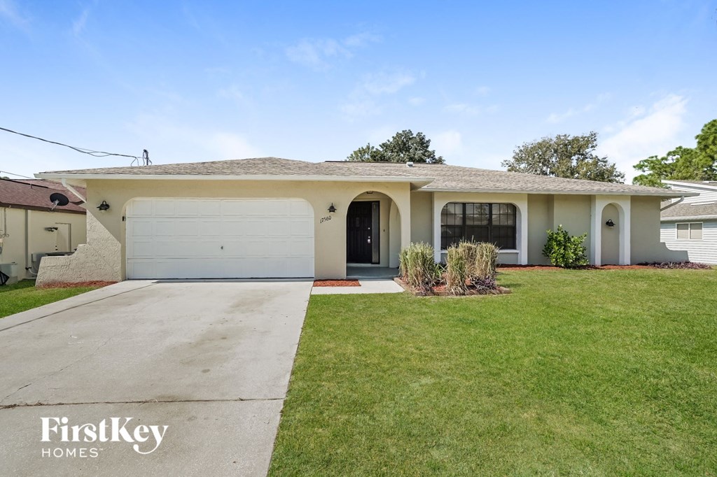 A house with a white garage door and a brown roof.