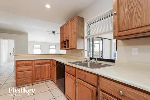 A kitchen with wooden cabinets and a sink.