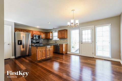 A kitchen with wooden cabinets and a refrigerator.