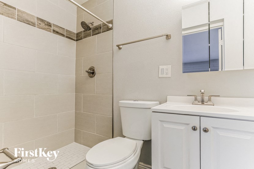 a white bathroom with a toilet and a sink