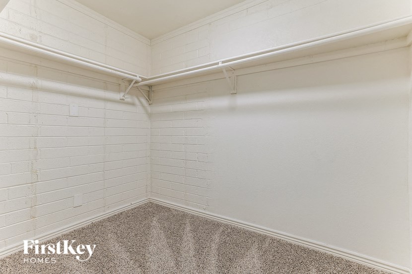 a white room with white brick walls and a carpet
