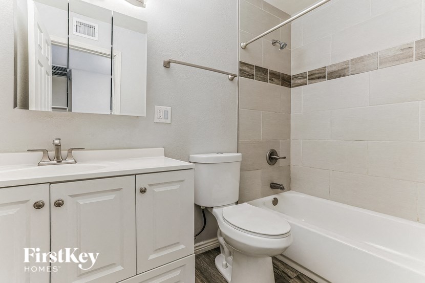 a white bathroom with a sink toilet and tub