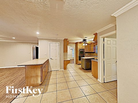 the kitchen is open to the living room and dining room