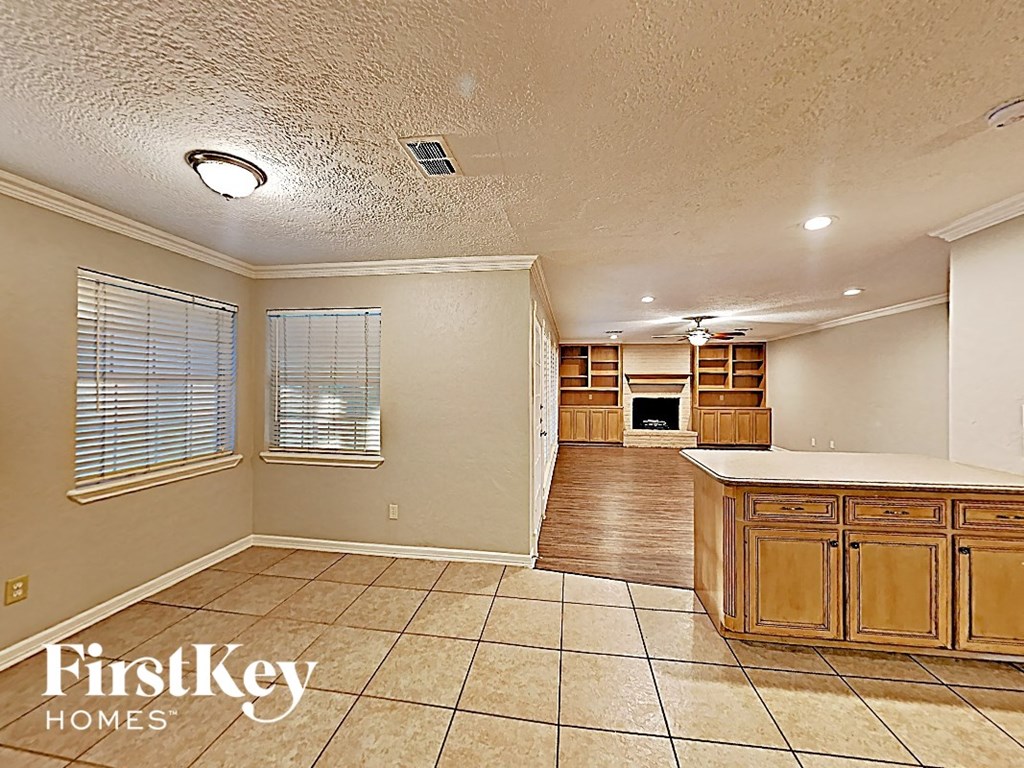 the kitchen and living room of an empty house