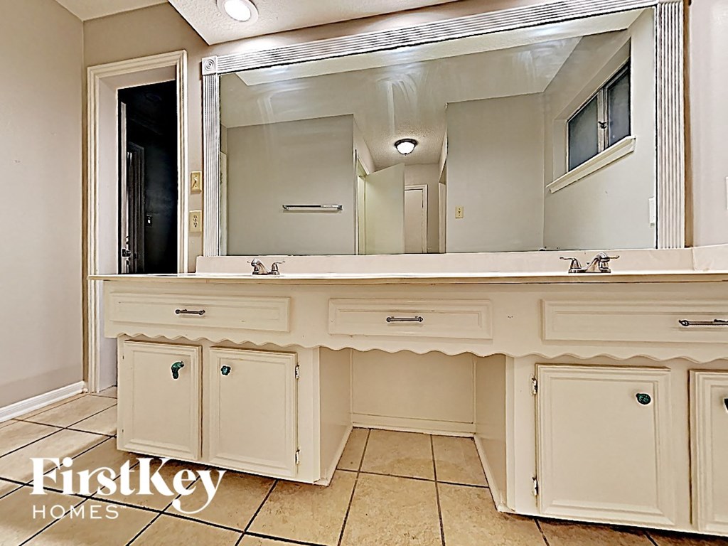 a bathroom with a large vanity with a mirror