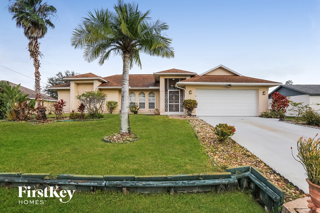 A house with a palm tree in front of it.