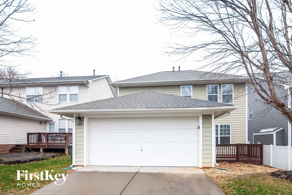 a white garage door in front of two houses