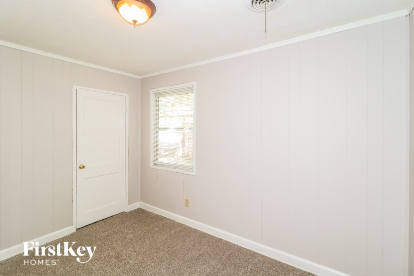 A white room with a door and a window.