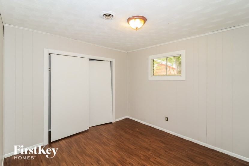 A room with a white door and a window with a white frame.