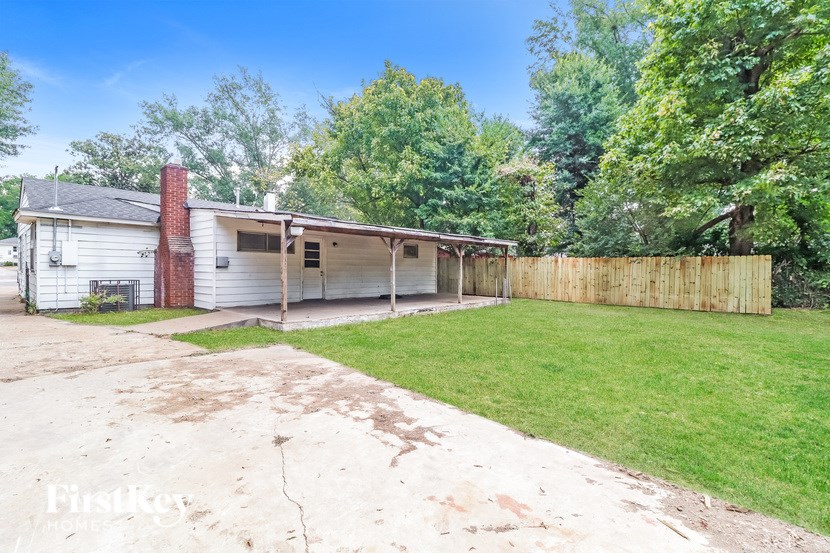 A house with a garage and a driveway in front of it.