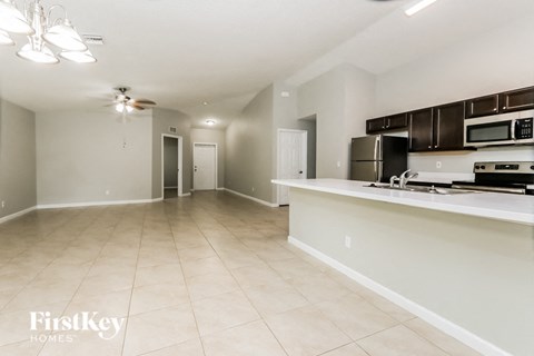 A kitchen area with a countertop and a microwave.