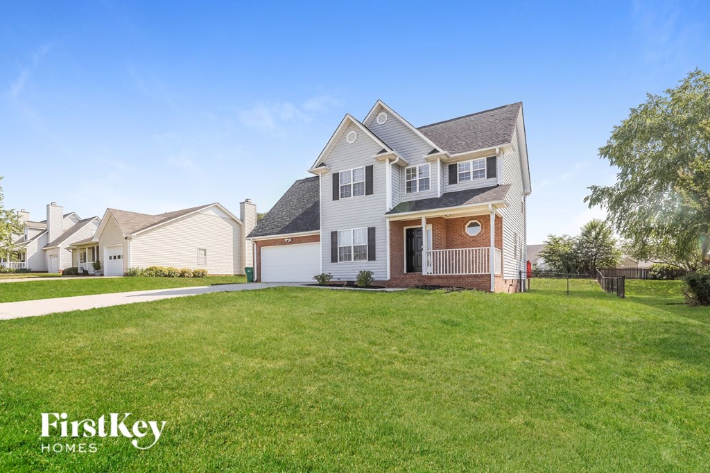 A large house with a well-kept lawn in front of it.