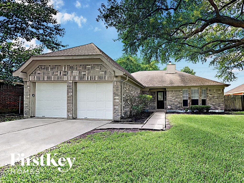 a house with a lawn and a garage