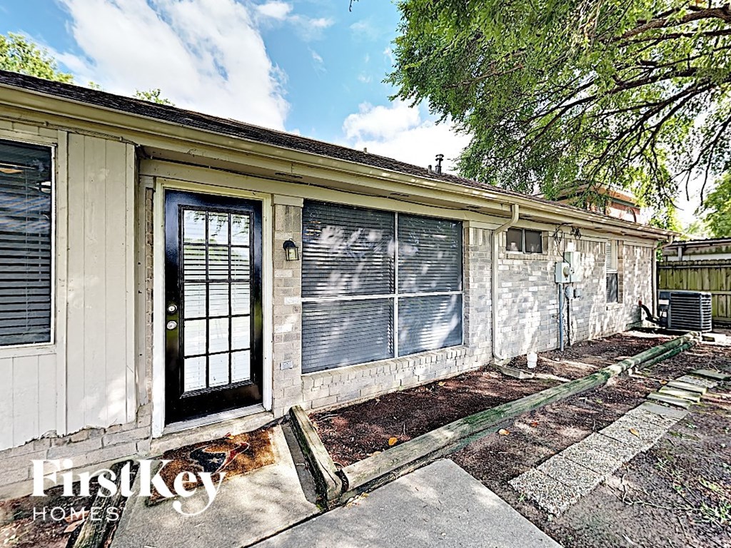 the outside of a small house with windows and a door