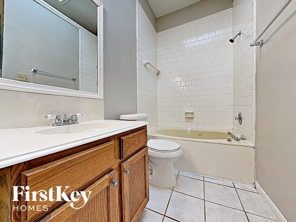 a bathroom with a toilet and a sink and a mirror
