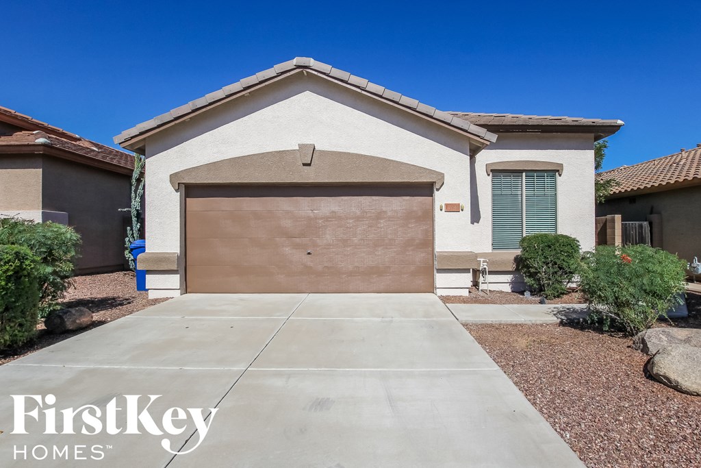 a home with a garage door in front of it