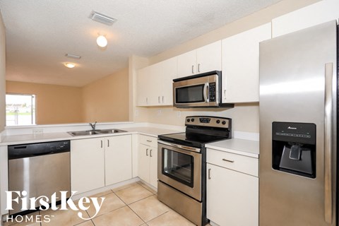 A kitchen with a FirstKey Homes logo.