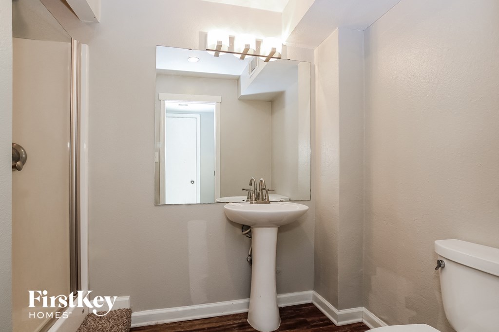A white sink in a small bathroom.