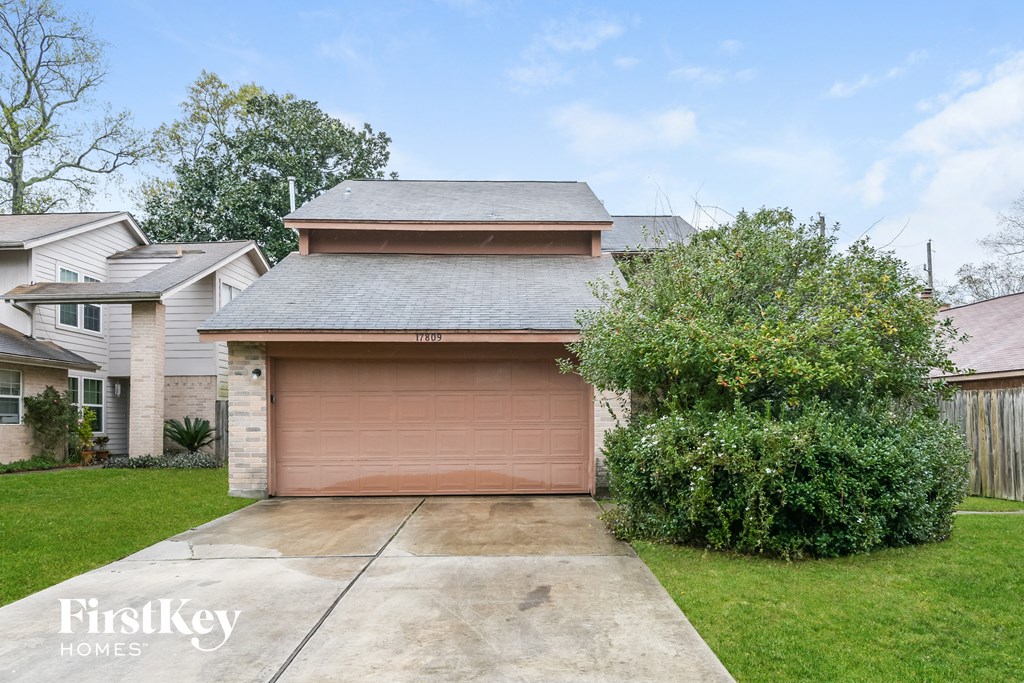 a garage with a brown garage door in a yard