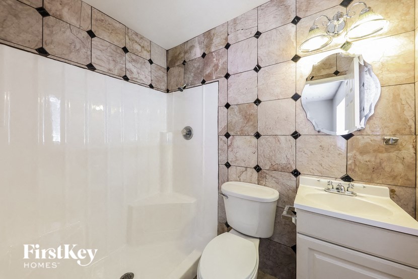 a white bathroom with a toilet and a sink