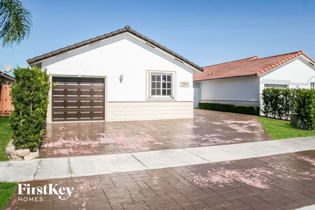 A house with a brown garage door and a white wall.