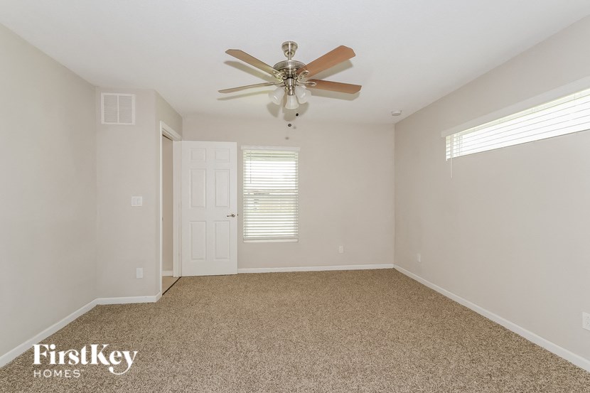the living room of a home with a ceiling fan