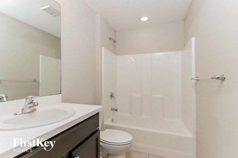 a bathroom with a sink toilet and a shower