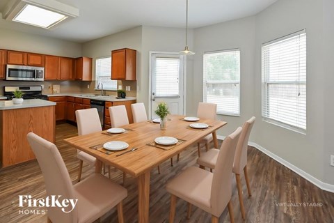 A kitchen with a dining table set for four.