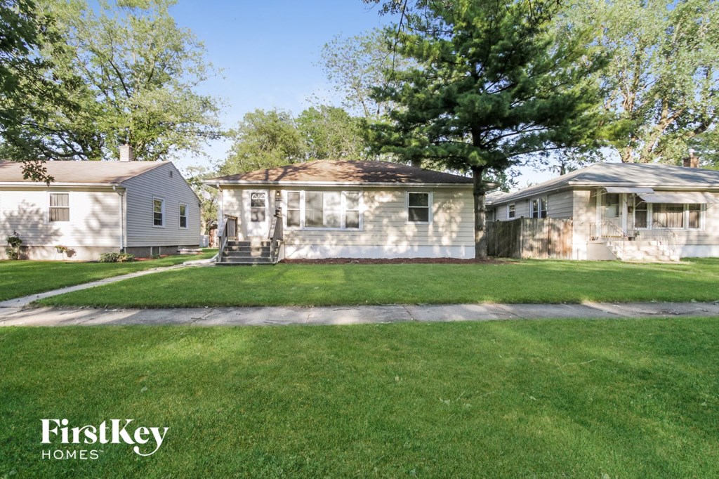 a white house with a yard in front of it