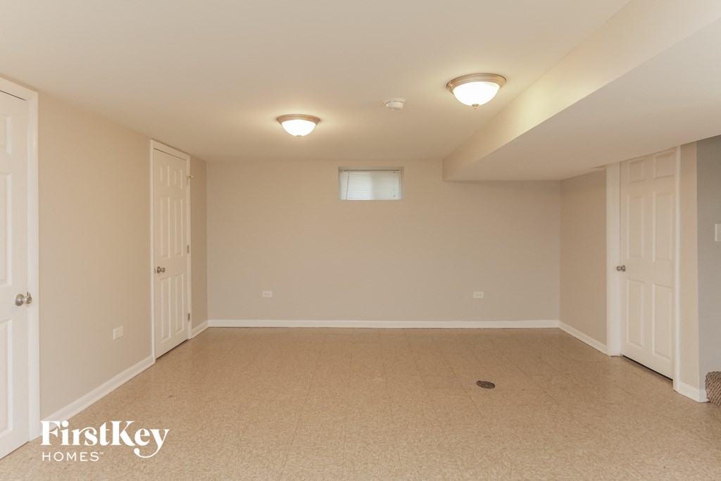 a empty room with two doors and a window