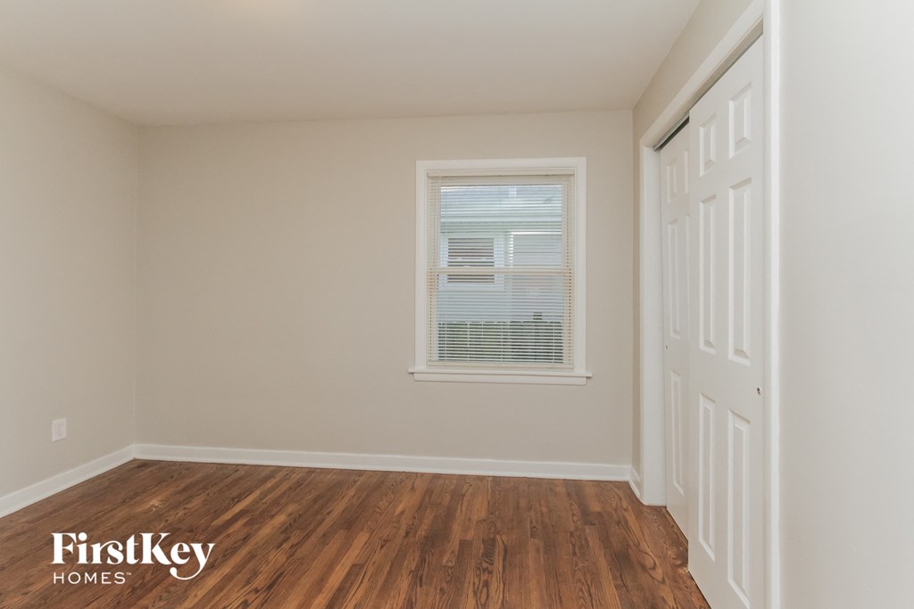 the interior of a home with wooden floors and a window