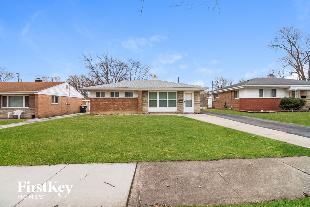 A house with a lawn in front of it.