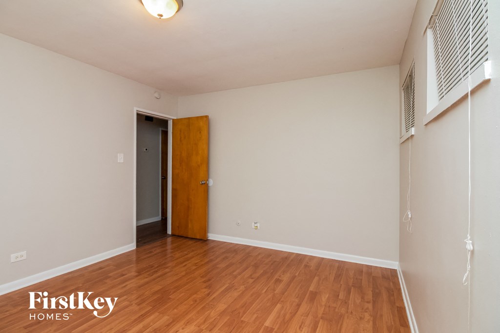 A room with a wooden floor and a door.