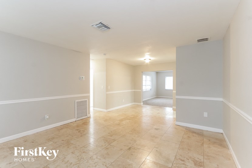 an empty living room and dining room in a house