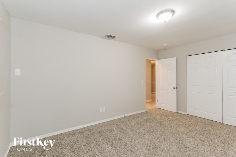 a bedroom with two closets and a door to a hallway