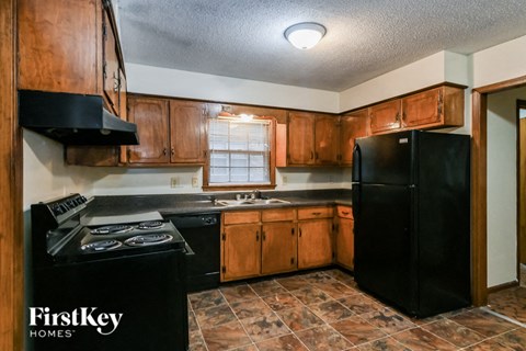 a kitchen with black appliances and wooden cabinets