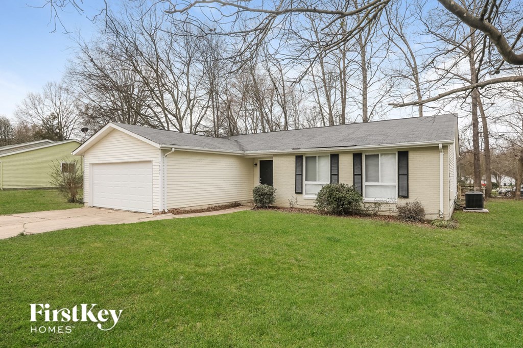 A house with a white garage door is for sale.