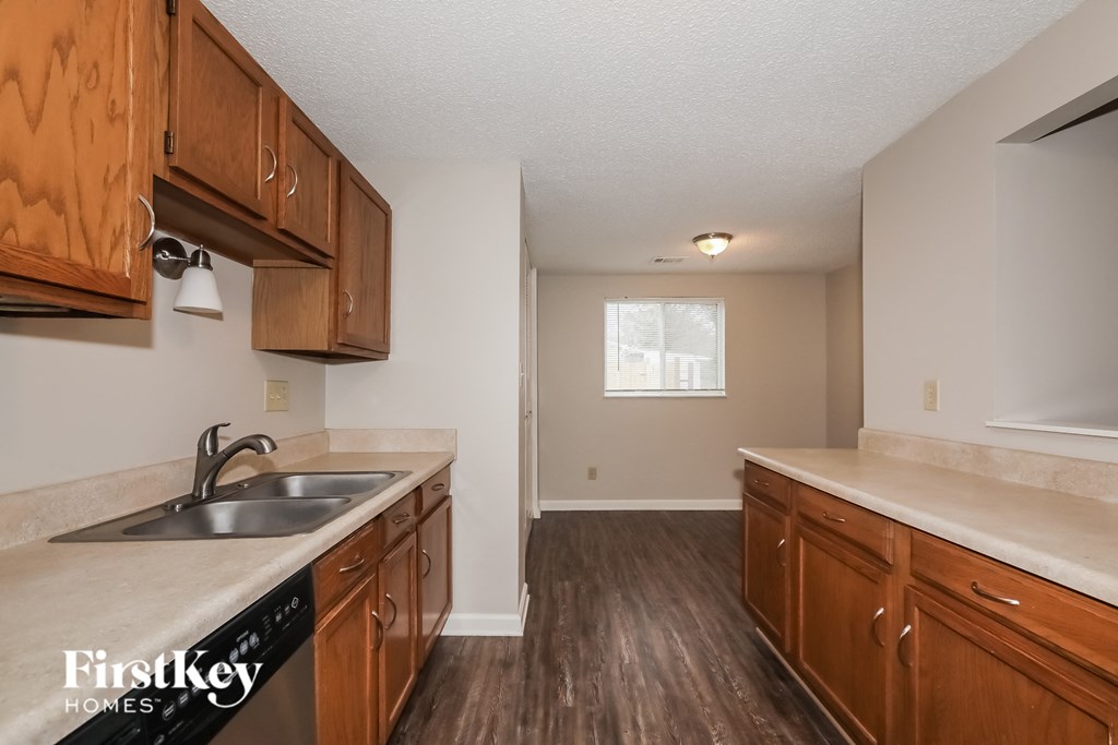 A kitchen with wooden cabinets and a sink.