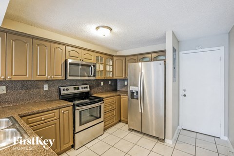 a kitchen with stainless steel appliances and wooden cabinets