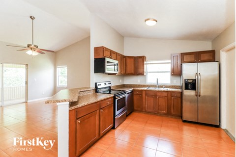 a kitchen with wooden cabinets and stainless steel appliances