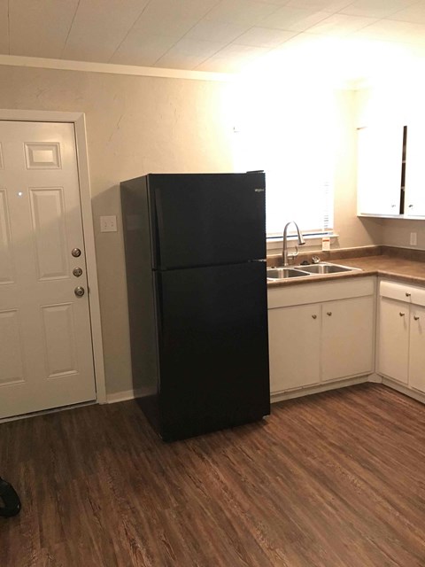 a kitchen with a refrigerator and a sink