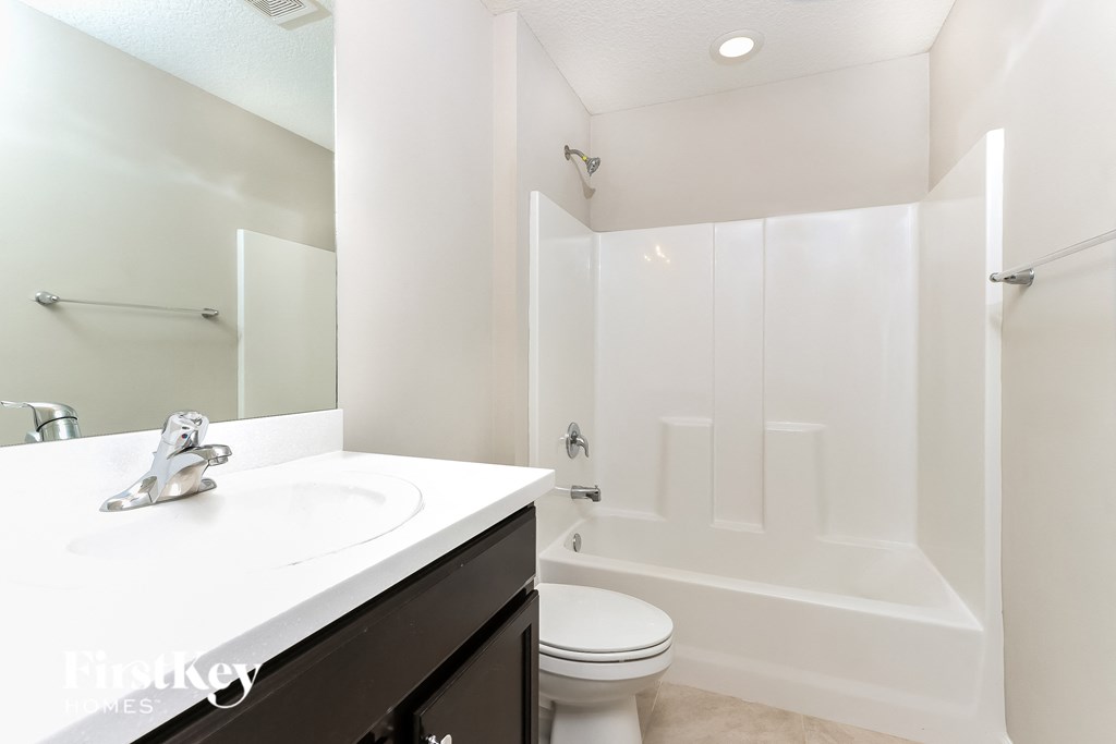 a bathroom with a sink toilet and a shower