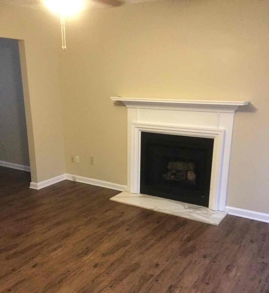 A white fireplace with a fire inside it.
