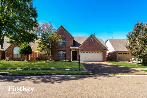 A house with a driveway in front of it.