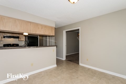 A kitchen area with a counter and a fridge.