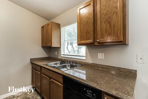 A kitchen with wooden cabinets and granite countertops.